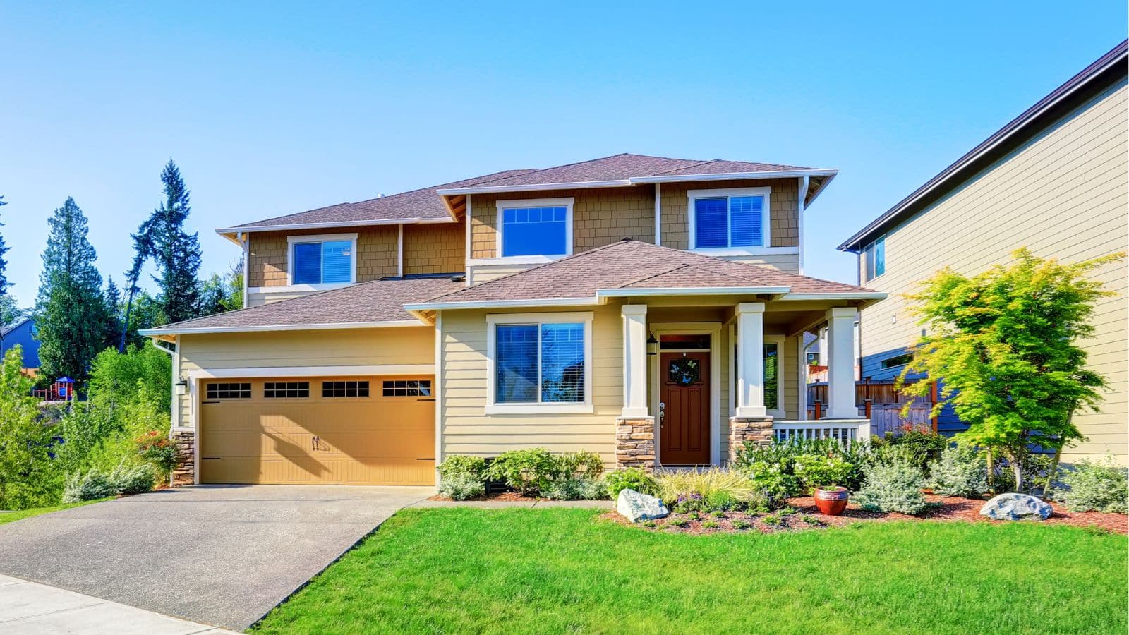 beautiful curb appeal of luxury beige house by irina88w from getty images via canva